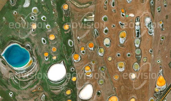 Das Satellitenbild "BEAUMONT - Australien" ist dem Bildband "HUMAN FOOTPRINT - Satellitenbilder dokumentieren menschliches Handeln" entnommen. Bildbeschreibung: Neben dem trockenen Klima hat die Landwirtschaft im Südwesten Australiens stark mit der Versalzung der Böden zu kämpfen. Weite Ackerflächen sind mit Salztümpeln durchsetzt, die von Algen unterschiedlich gefärbt sind und beim Verdunsten des Wassers helle Salzkrusten ausbilden.