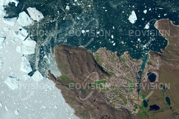 Das Satellitenbild "ILULISSAT - Grönland" ist dem Bildband "NEW HUMAN FOOTPRINT - Unsere Welt im Umbruch" entnommen. Bildbeschreibung: Nördlich des Polarkreises sind die Lebensbe­dingungen für Menschen hart. Ilulissat liegt am Nordufer der Mündung des Ilulissat Eisfjords, in den der Gletscher Jakobshavn Isbrae mündet. Dieser ist mit einer Fließge­schwindigkeit von 20-35 Metern pro Tag ei­ner der am schnellsten fließenden Gletscher Grönlands und liefert ständig große Mengen von Eisbergen. Daher stammt auch der Name der Stadt: Ilulissat bedeutet Eisberge. Wegen der spektakulären Drift der Eisberge hat sich Ilulissat zur wichtigsten Tourismus­destination in Grönland entwickelt.